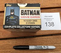 Box top view showing Batman image, Topps logo, and text indicating 143 glossy cards and 22 stickers with original gold seal.