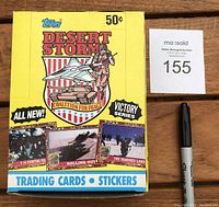 Front view of the unopened yellow box showing Topps Desert Storm branding, 50 cent price, and military-themed graphical elements.