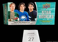 Front and top view of 2022-23 Upper Deck NHL Star Rookies box set showing three hockey players and box branding.