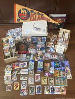 Overall lot view showing loose cards, boxes, pennant and trophies