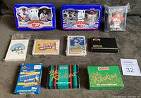 Photo showing the full lot including 2 Donruss Preferred tins, multiple card puzzle boxes from Donruss The Rookies 1988 and 1990, Topps sets, and sealed smaller packages.