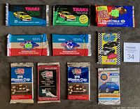 Full lot of 10 unopened packs showing various car and racing trading card packs including Traks editions, Pro Set Winston Cup and NHRA, Classic Monster Trucks and others.