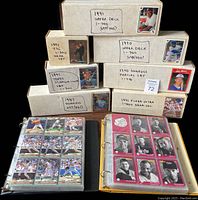 Photo of nine labeled boxes and two binders showing various baseball card sets with partial and near complete numbers.