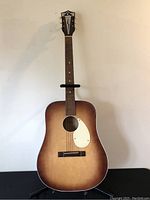 Full front view of Kay L9325 acoustic guitar displaying dreadnought body, sunburst finish, rosewood fretboard and headstock