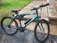 Full photo of the green CCM Mega Oversized 20" mountain bike showing frame, tires, seat, and handlebars with attached water bottle and lock.