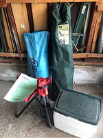 Camping lot items grouped including Outbound tent bags, folding chair, cooler, camping stools