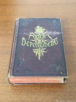 Front cover showing "Our Deportment" title embossed with gold lettering and floral motifs