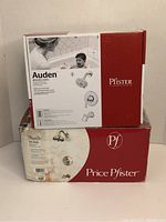 Photo showing two boxed Pfister faucet sets: Auden in chrome finish and Marielle in brushed nickel, stacked on each other.