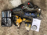 Full lot view showing all power tools together including saws, drills, blades, and manual