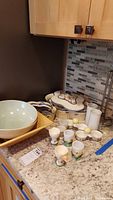 Countertop view of assorted dishware including egg cups, casserole dishes, and bowls