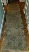 Full view of one hallway rug on hardwood floor showing size and pattern