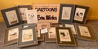 Wide shot showing 14 framed cartoons by Ben Wicks with visible handwritten captions and neutral mats.