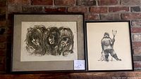 Photo of two framed drawings against brick wall, left drawing shows three faces by Mercer, right drawing shows backward facing figure by James Houston.