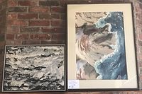 Two framed abstract paintings on brick wall, one predominantly blue and brown with wave-like forms, the other black and white textured abstract.