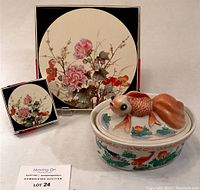 Round floral Pimpernel coaster and placement in original boxes with ceramic fish dish featuring lid with fish figurine.