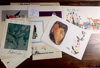 Set of multiple unframed prints showing variety of art styles and sizes.