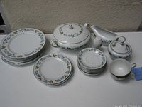 Complete set of 23 pieces displayed including plates, cups, covered dish, gravy boat, sugar bowl with lids