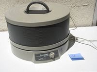 Front view of Honeywell Enviracaire HEPA air filter unit, showing the cylindrical shape, top handle, mesh filter section, and rotary dial control.