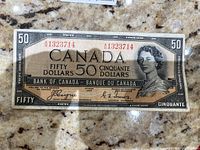 Front of uncirculated 1954 Bank of Canada $50 note showing portrait and serial number
