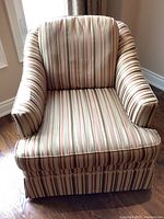 Front view of the upholstered Barrymore chair showing the striped fabric upholstery and curved arm design.