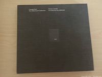 Closed black hardcover stamp book with silver text and emblem on front marked Canada Post The Millennium Collection