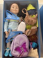 Maplelea Girl doll with clothing and accessories inside the box
