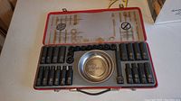 Full view of red metal Stanley FatMax case open showing array of impact sockets, a magnetic tool tray, and socket extensions inside.
