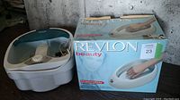 Photo showing Revlon MoistureStay paraffin bath unit and box side by side on a surface.