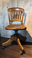 Front view of vintage wooden task chair showing slatted backrest and contoured seat