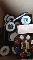 Photo showing NHL team coasters with logos including Toronto Maple Leafs and Tampa Bay Lightning, and a poker chip set in caddie.