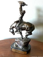 Front three-quarter view showing mounted figure, horse and base nameplate.