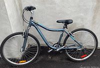 Full left side view of women's step-through mountain bike showing frame, front suspension fork, wheels and pedals