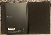 Back of Sony e-reader device showing model and branding with the protective case.