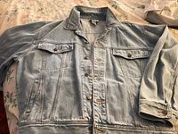 Full view of Blue Dream denim jean jacket laid flat showing front buttons, collar, pockets, and cuffs.