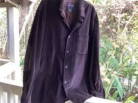 Full front view of the brown faconnable corduroy jacket with button closure, single chest pocket, and leather elbow patches.