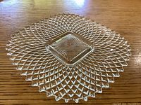 Top-down view of the square clear glass dish showing the detailed diamond texture pattern and starburst center design.
