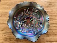 Top view of carnival glass bowl, showing acorns and oak leaves pattern inside.