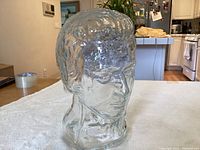 Clear heavy glass bust sculpture of Thomas Jefferson's head angled view