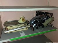 Photo showing the Rival electric meat slicer and two Exacta weigh scales on a shelf.