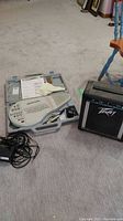 Overall view of Omnichord in case with manual, adapter, cable and Peavey amplifier
