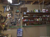 Overview of wall and shelving displaying hardware jars, cables, brushes, trowels, bulbs, and other tools.