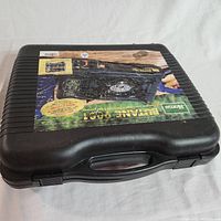 Closed black plastic carrying case with handle, worn product label showing Home Butane 9001 stove.