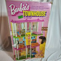 Box of Barbie Townhouse showing 3 floors, elevator, and depiction of furniture arrangement inside townhouse