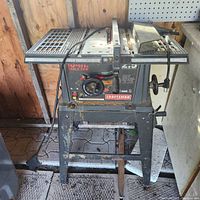 Front view of Craftsman 10-inch table saw showing overall condition and stand.