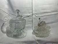 Two crystal covered bowls, one shaped as a turkey and the other as a swan, side by side showing details and scale.
