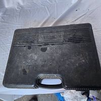 Closed black plastic case with Mastercraft logo embossed