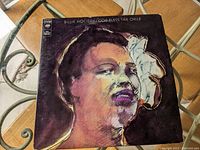 Front cover of vinyl album showing stylized portrait of Billie Holiday and album title