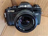 Front view of Minolta X-700 camera with Minolta 50mm f/1.7 lens showing lens face and camera front details.
