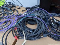 Overview of bundled live sound and recording cables showing variety of connector types and cable colors.