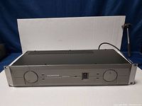 Front view of Samson SERV-O 150 studio amplifier showing control knobs, power switch, and branding on silver panel with black top casing.
